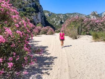 Hiker on a sandy path in Sardinia