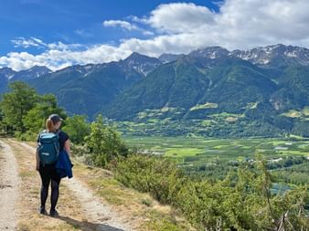 Hiker gazes at the breathtaking landscape in the Vinschgau