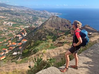 Hiker enjoys the view of Cabo Girão and Funchal