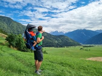Hikers with back stretcher and breathtaking panoramic views in South Tyrol