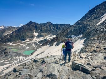 Hikers on the way to the turquoise-blue mountain lake in Sölden