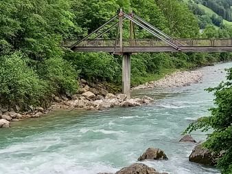 Old bridge over a river in the middle of a forest