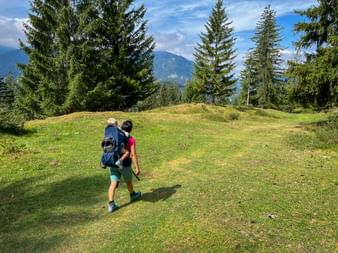 Hiker with child on an alpine meadow