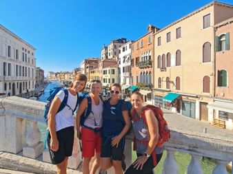 Hiking group on a bridge in Venice