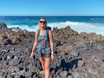 Employee Julia on the rocky beach of Tenerife
