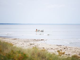 Fishermen in a boat on the beach in Österlenleden