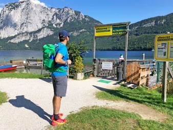 Hiker at the boat landing stage in Altausee