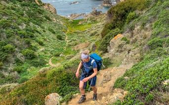 Hiker on the coastal path in Spain