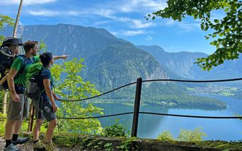 Family hiking on the Soleweg with a view of the Salzberg and Lake Hallstatt