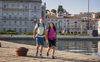Hiking couple in the port of Trieste