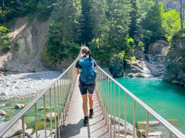 Hiker on the Traversinersteg bridge in the Viamala Gorge in Graubünden Hiker on the Traversinersteg bridge in the Viamala Gorge in Graubünden