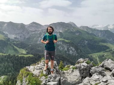 Employee Florian at the summit of the Jenner