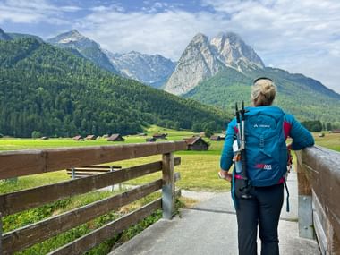 Hiker enjoys the view of the Zugspitze Hiker enjoys the view of the Zugspitze