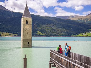 Beautiful view of the church tower in Steg on Lake Reschen