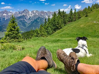 Hiking boots in front of a mountain panorama