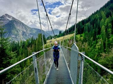 Hiker on Holzgau suspension bridge
