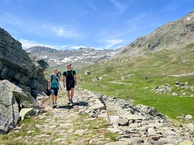 Hikers at the Splügenpass in Switzerland Hikers at the Splügenpass in Switzerland