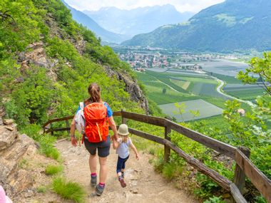 Woman with child on hiking trail between Naturno and Parcines