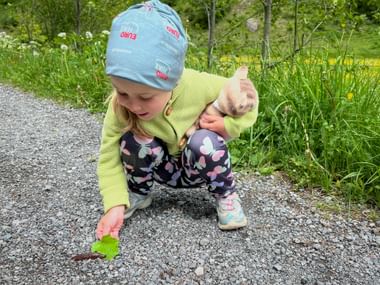 Young hiker observes snail