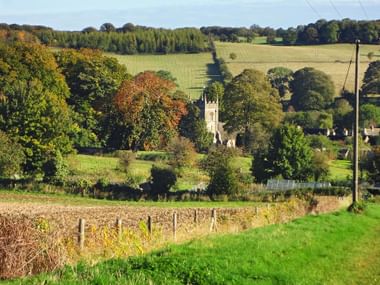 Blockley church surrounded by fields, woods and hills