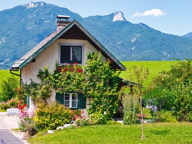 Idyllic house by the wayside with mountain panorama in the background
