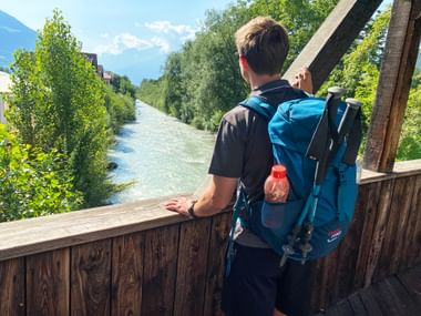 Hiker on a bridge over the Adige