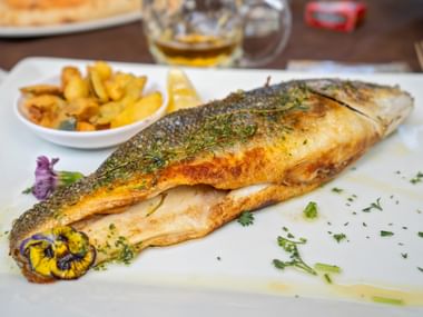Fried trout with flower decoration