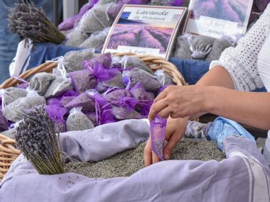 Getrocknete Lavendelblüten in großen Säcken, Lavendelblüten werden händisch in kleine Duftsäckchen abgefüllt