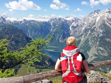 Hiker in front of Koenigssee panorama