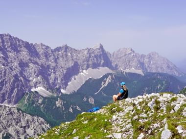 Hiker with a view of a rocky mountain massif