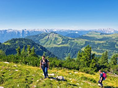 Two hikers on the Postalm with mountain panorama
