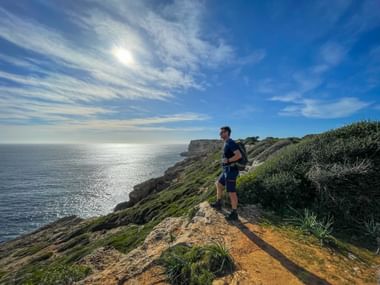 Hikers at the Ses Falconeres cliffs with panoramic views of the sea