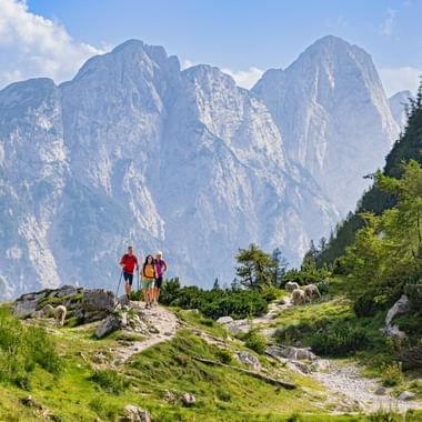 Hikers at the Vršič Pass with panoramic views of the mountains
