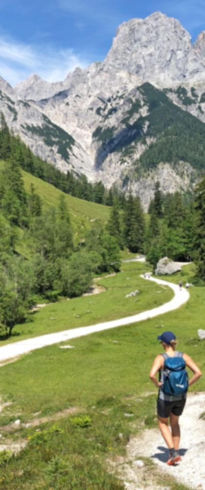 Hiker in the Klausbach valley with a view of the Reiter Alpe