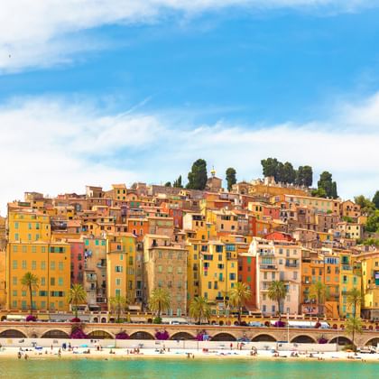 View over the sea to the colourful houses of the town of Menton on the Côte d'Azur