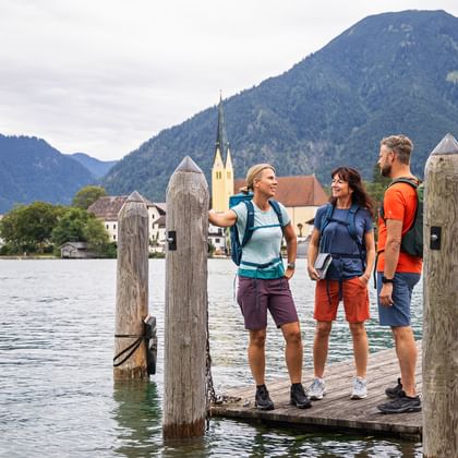 Three hikers enjoy the peace and quiet by the lake