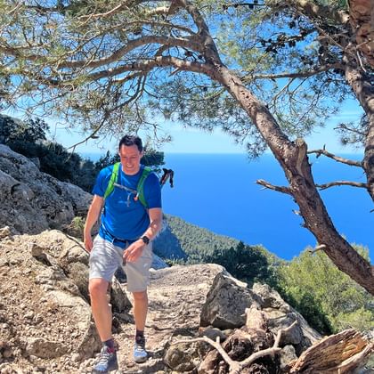 Hiker on a mountain in front of the sea