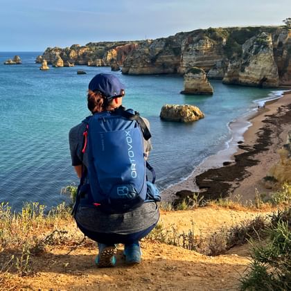 Hiker enjoys the view of the Praia da Dona Ana