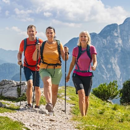Hiking trio at the Vršič Pass on the Alpe-Adria Trail in Slovenia
