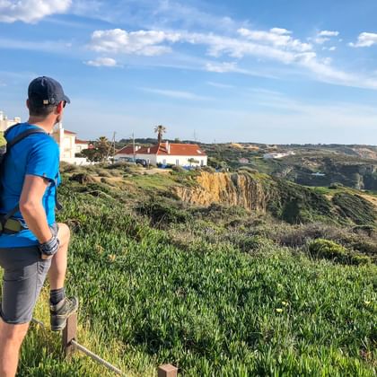 Hiker on a hiking trail with a view of the coast
