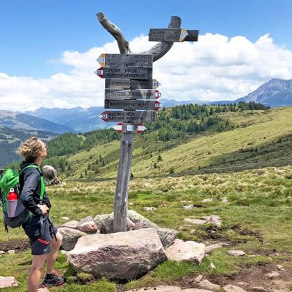 Hiker at a signpost Circular walk in Mölten