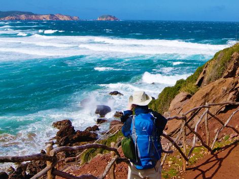 Wanderer mit Panoramablick aufs Meer auf Menorca
