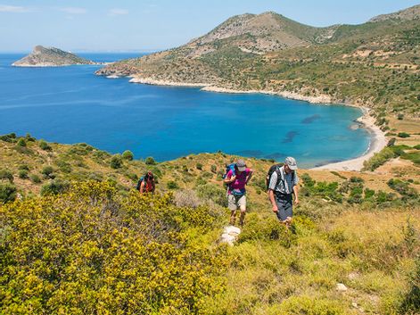 Hikers along the coast with a beautiful view of the turquoise sea