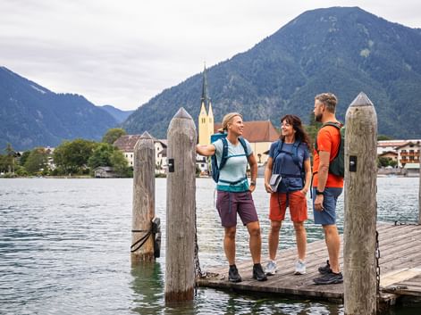 Three hikers enjoy the peace and quiet by the lake