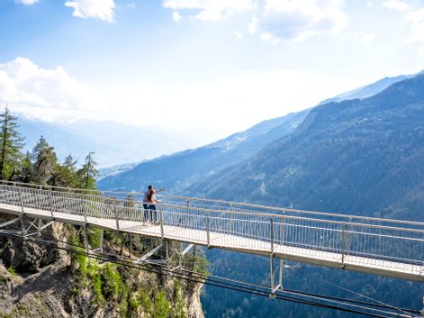 Hikers on an airy suspension bridge