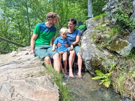 Happy family by a stream in South Tyrol