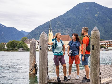 Three hikers enjoy the peace and quiet by the lake