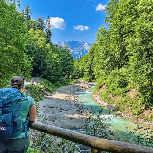 Hiker looks down on stream bed at Partnachklamm gorge