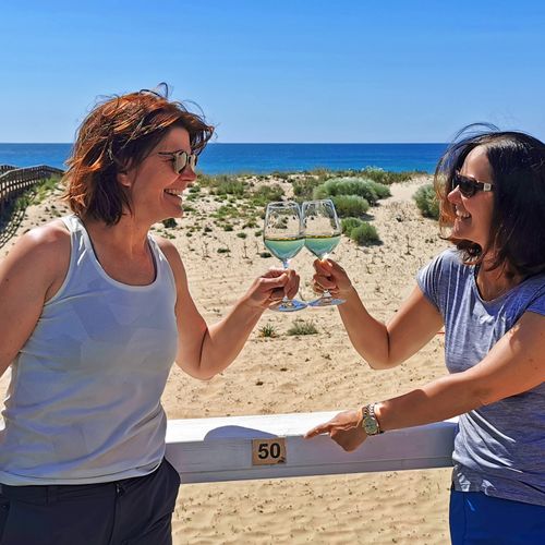 Two hikers toast on the beach