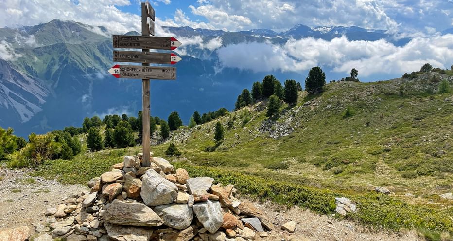 Mountain panorama on the Haideralm with a wooden signpost stuck in a cairn